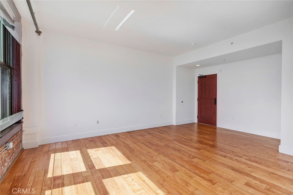460 South Spring Street, Unit 802 Los Angeles, CA 90013 - Photo 18 of 25 a view of an empty room and wooden floor