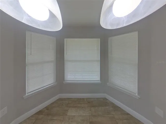 an empty room with windows and closet