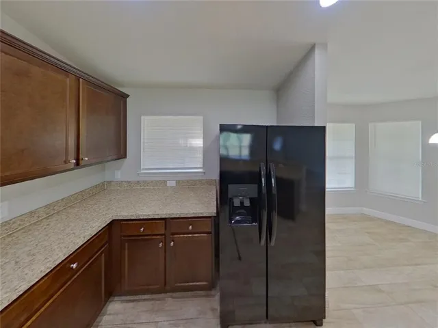 a kitchen with a refrigerator and cabinets