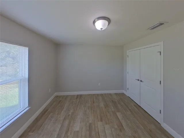 a view of a room with wooden floor and white walls