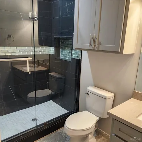 a bathroom with a toilet and a shower