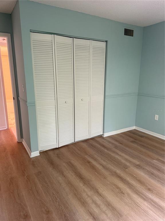 1236 Pine Ridge Circle West, Unit G3 Tarpon Springs, FL 34688 - Photo 16 of 18 a view of empty room with wooden floor
