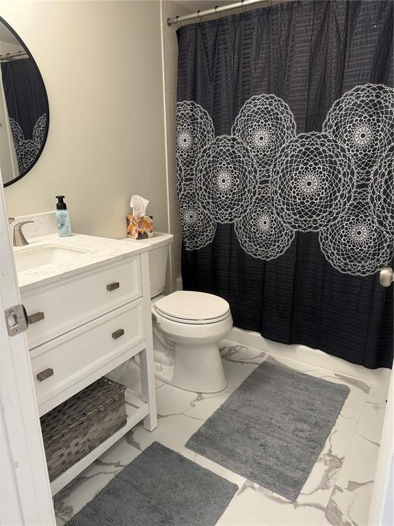 1236 Pine Ridge Circle West, Unit G3 Tarpon Springs, FL 34688 - Photo 18 of 18 a bathroom with a toilet a sink and mirror