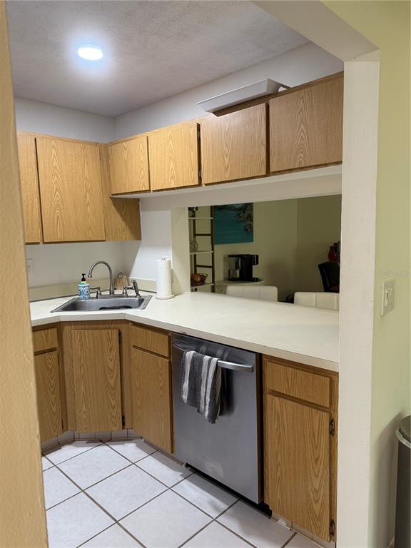 1236 Pine Ridge Circle West, Unit G3 Tarpon Springs, FL 34688 - Photo 5 of 18 a kitchen with granite countertop a sink and cabinets