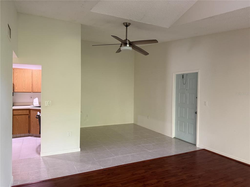 1236 Pine Ridge Circle West, Unit G3 Tarpon Springs, FL 34688 - Photo 8 of 18 an empty room with wooden floor a ceiling fan and windows