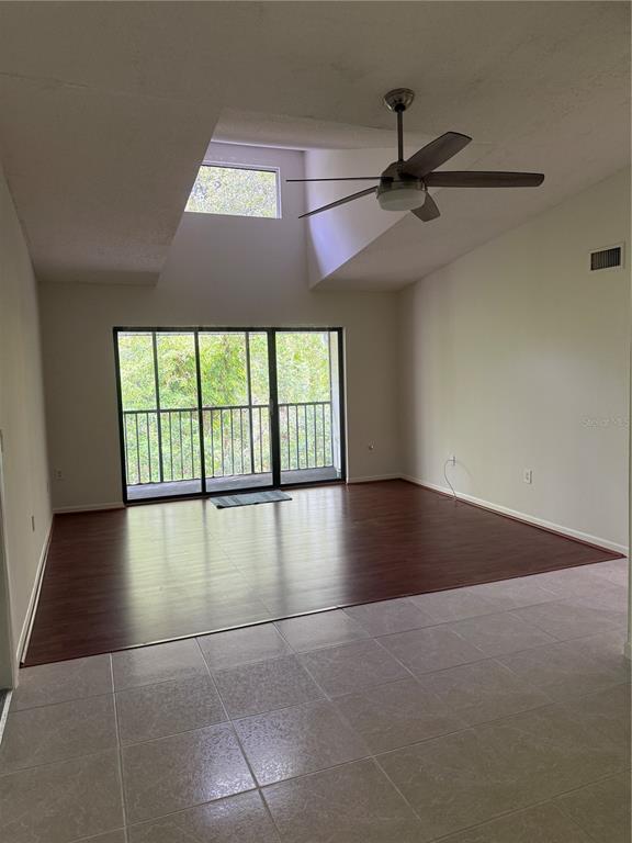 1236 Pine Ridge Circle West, Unit G3 Tarpon Springs, FL 34688 - Photo 10 of 18 an empty room with windows and ceiling fan