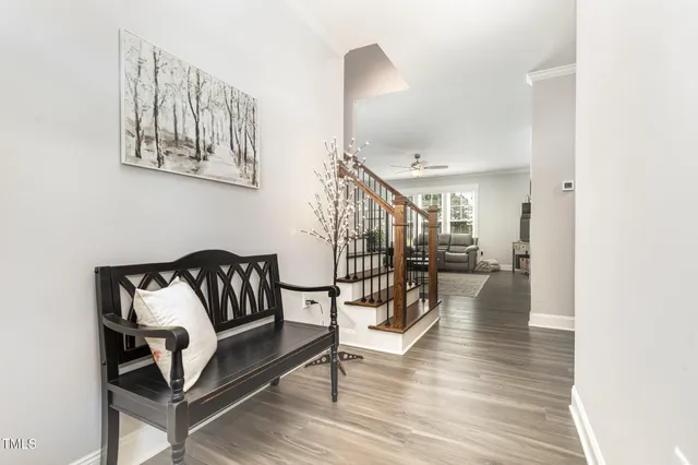 a view of entryway and hall with wooden floor