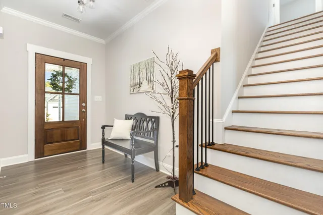 a view of entryway and hall with wooden floor