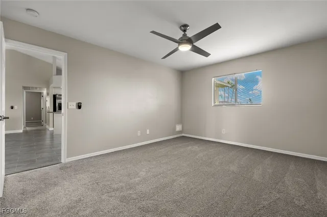 a view of an empty room with a ceiling fan