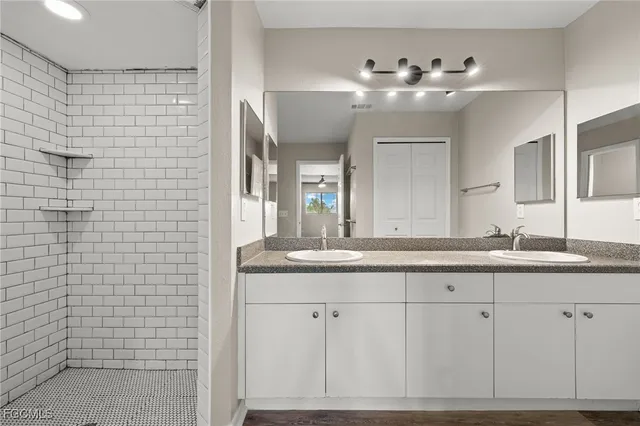 a bathroom with a double vanity sink and a mirror