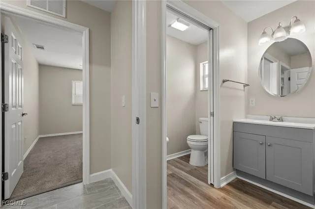 a en suite bathroom with a sink a large mirror and a bathtub
