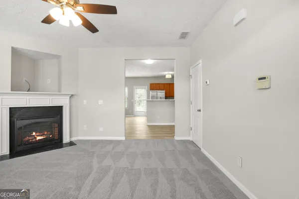 a view of an empty room and fire place