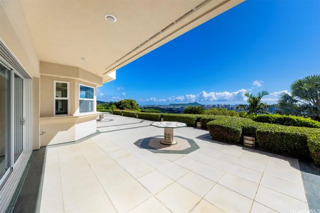 a view of a patio with couches table and chairs and potted plants