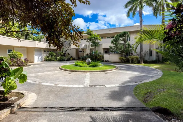 a view of a house with a yard and garden