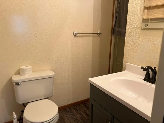 a bathroom with a sink a toilet and mirror