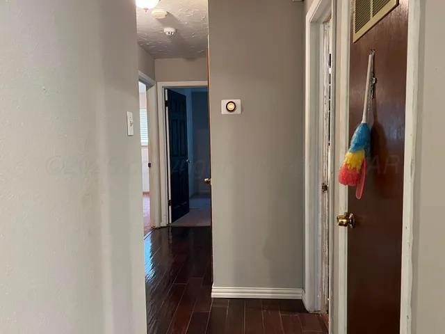 a view of hallway with wooden floor