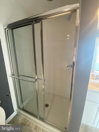 a bathroom with a glass shower door