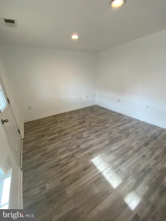 a view of a room with wooden floor