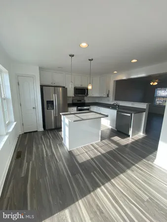 a view of a kitchen with a sink and cabinets