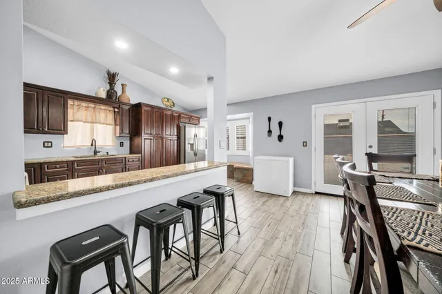 a large white kitchen with sink and cabinets