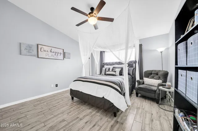 a bedroom with a bed lamp closet and a large window