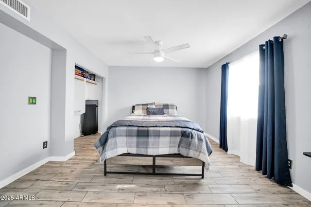 a bedroom with a bed and a table