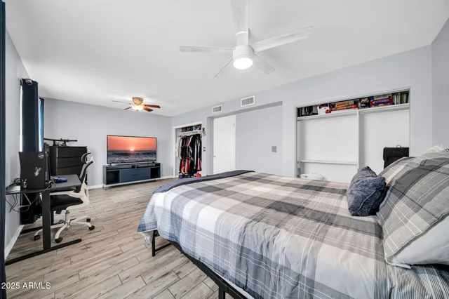 a bedroom with a bed and a flat screen tv