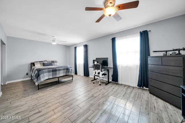 a bedroom with furniture and a wooden floor