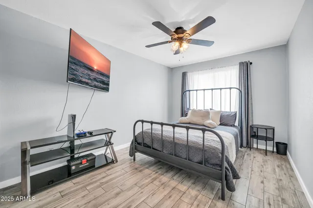 a bedroom with furniture and a flat screen tv