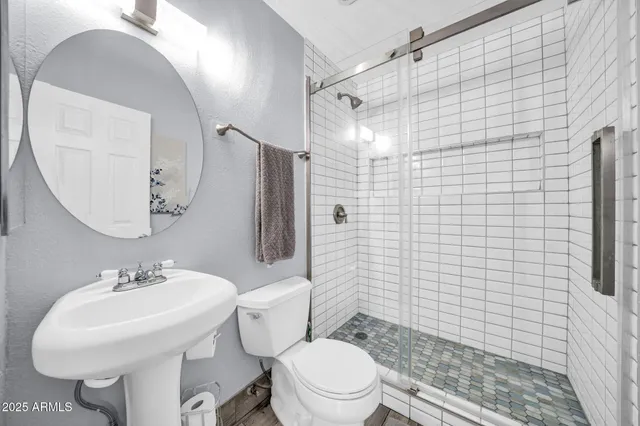 a bathroom with a sink toilet and shower