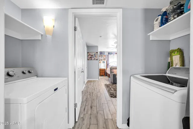 a view of washer and dryer with bathroom