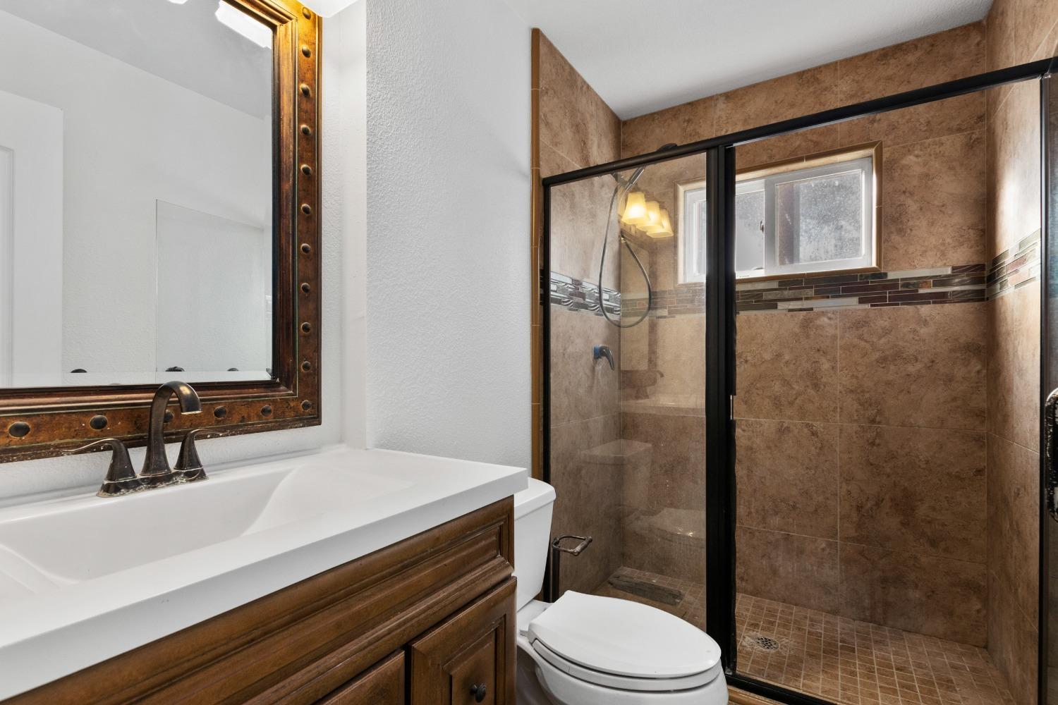 725 R Street Newman, CA 95360 - Photo 25 of 31 a bathroom with a sink a toilet and shower