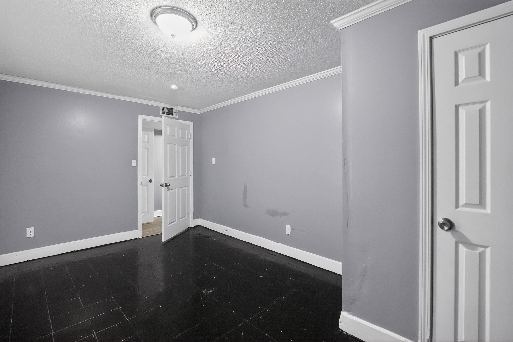 4199 Auburn Road Memphis, TN 38116 - Photo 12 of 32 Room featuring dark wood-finish flooring, light gray walls, and white crown molding