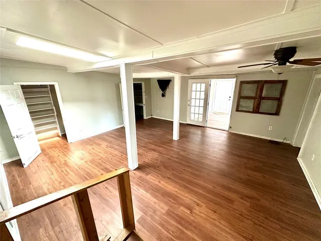 a view of hallway with wooden floor and floors