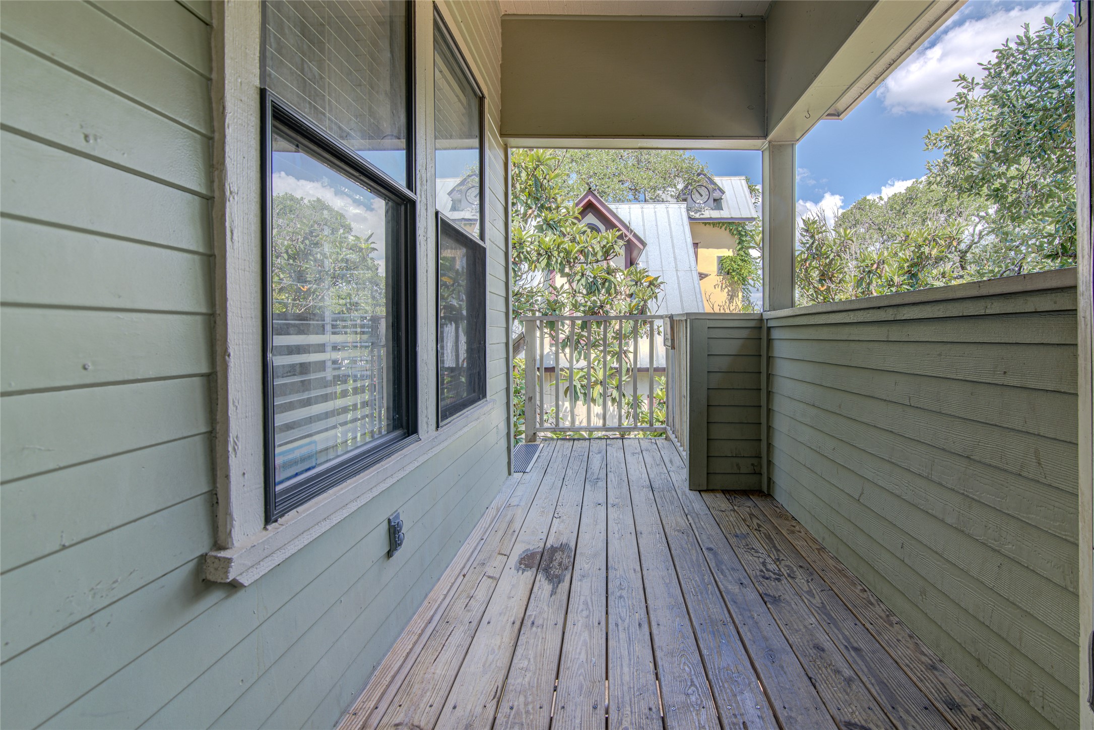 311 West Mary Street Austin, TX 78704 - Photo 4 of 35 Step out onto this charming covered porch, offering tranquil views of mature trees and surrounding neighborhood rooftops.