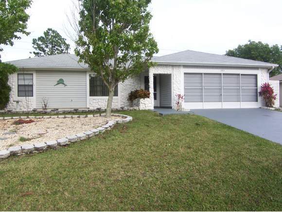 585 Northwest Higgs Palm Bay, FL 32907 - Photo 1 of 12 a view of a house with a yard and tree