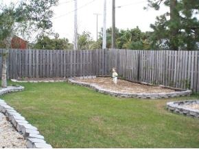 585 Northwest Higgs Palm Bay, FL 32907 - Photo 12 of 12 a backyard of a house with table and chairs