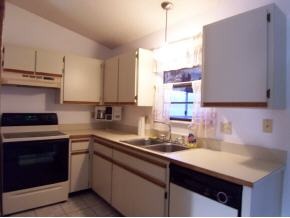 585 Northwest Higgs Palm Bay, FL 32907 - Photo 3 of 12 a kitchen with stainless steel appliances a sink stove and cabinets