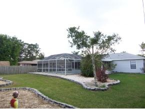 585 Northwest Higgs Palm Bay, FL 32907 - Photo 6 of 12 a view of a house with a yard and sitting area