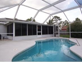 585 Northwest Higgs Palm Bay, FL 32907 - Photo 10 of 12 a view of a house with a large window and wooden fence
