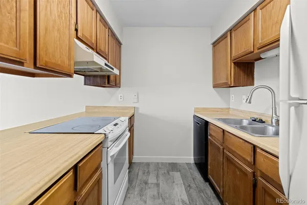 a kitchen with a stove a sink and a refrigerator