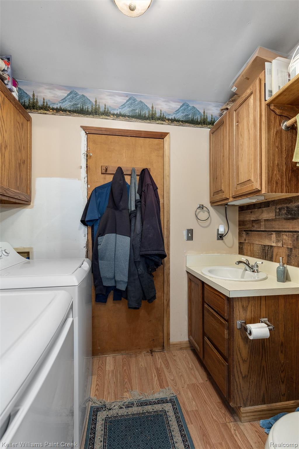 5077 Pinckney Road Howell, MI 48843 - Photo 21 of 39 Wood-finish flooring, wood cabinetry, built-in sink, and overhead illumination