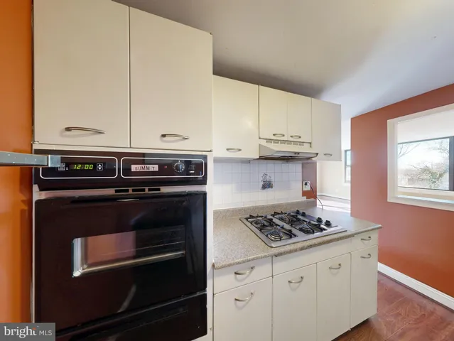a kitchen with stainless steel appliances granite countertop a stove a microwave and cabinets