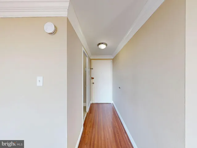 a view of a hallway with wooden floor