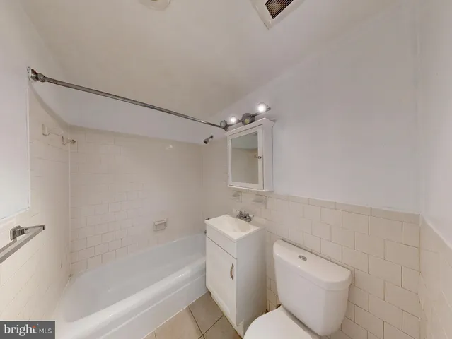 a bathroom with a toilet sink and shower