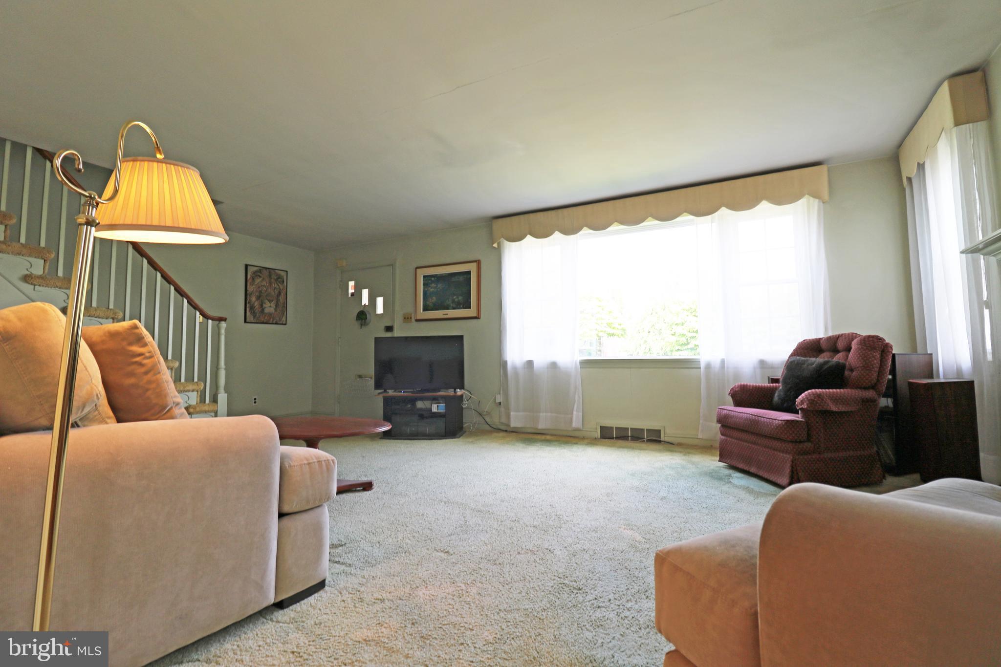 530 Hempstead Road Springfield, PA 19064 - Photo 6 of 36 a living room with furniture a large window and a flat screen tv