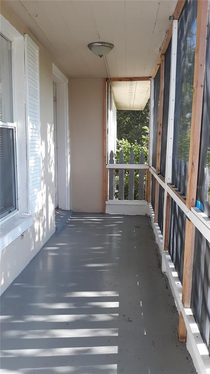 1530 South Martin Luther King Junior Avenue Clearwater, FL 33756 - Photo 2 of 11 a view of a porch with wooden floor and windows