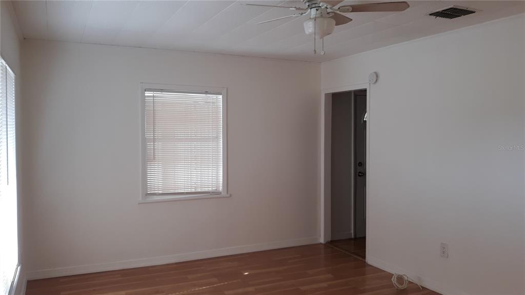 1530 South Martin Luther King Junior Avenue Clearwater, FL 33756 - Photo 3 of 11 an empty room with a window and a ceiling fan