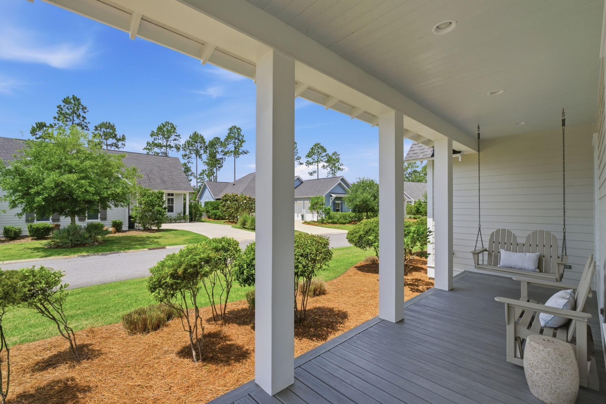 133 Sandchase Circle, Unit LOT 15 Inlet Beach, FL 32461 - Photo 5 of 47 a view of a porch with furniture and garden