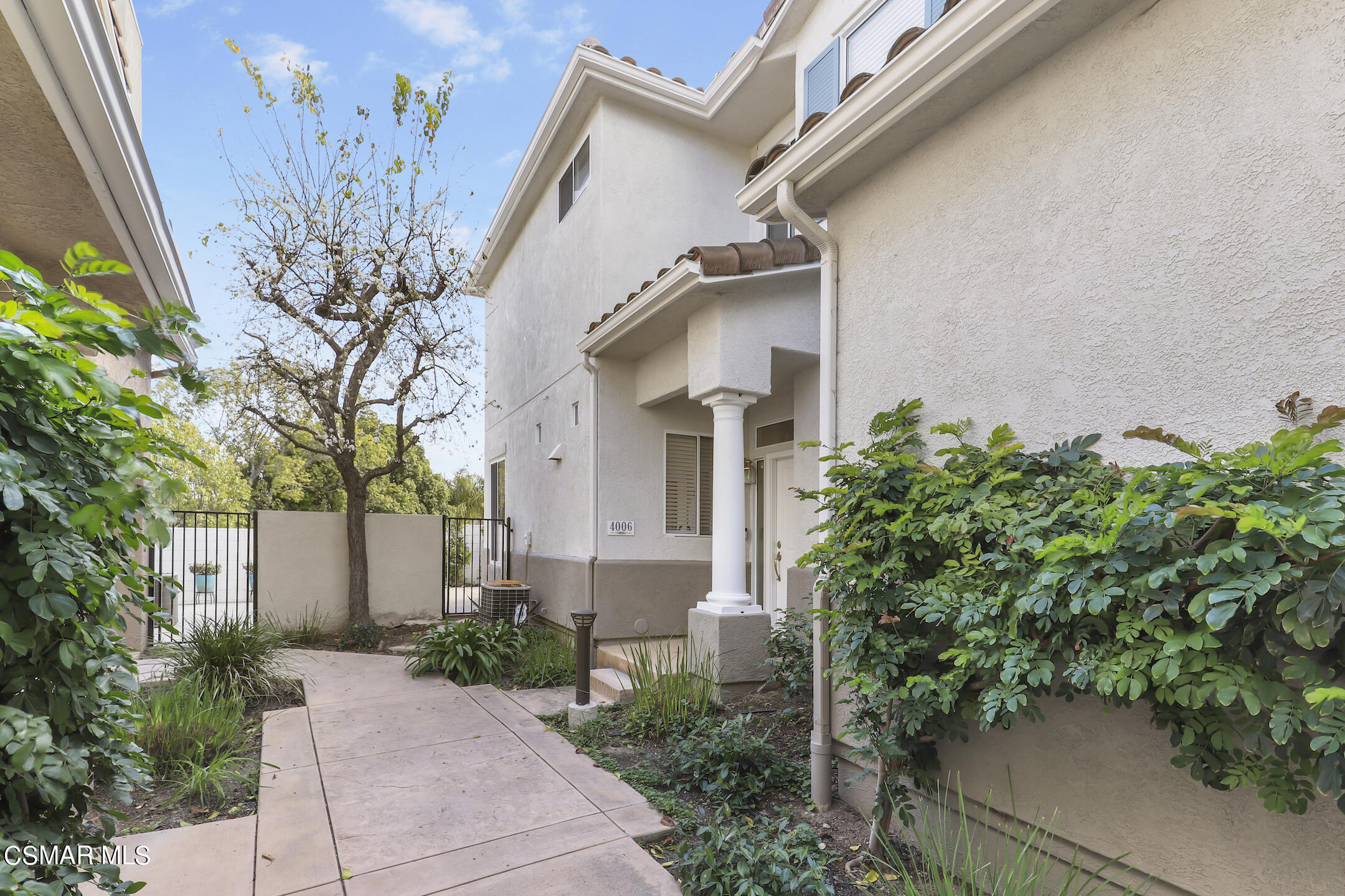a view of a house with a plants and pathway